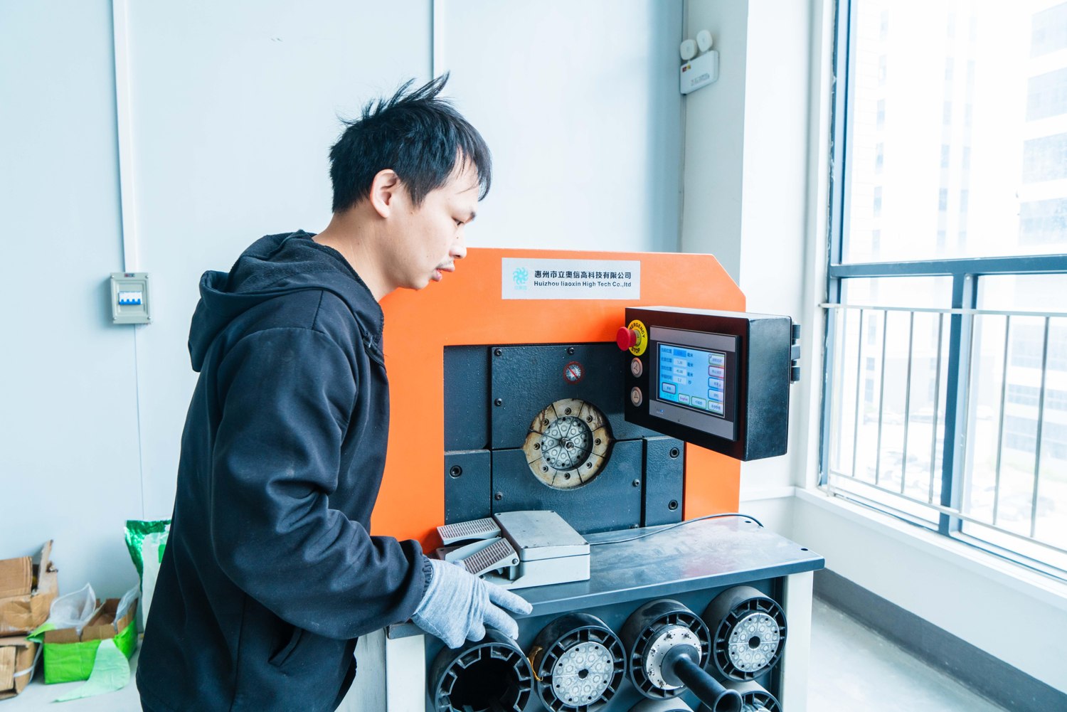 An operator working on hose end preparation equipment.